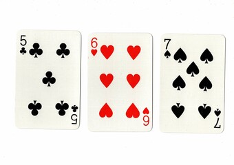 A hand of playing cards showing a run of three on a white background.