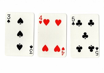 A hand of playing cards showing a run of three on a white background.