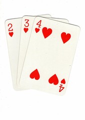 A hand of playing cards showing a run of three on a white background.