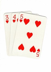 A hand of playing cards showing a run of three on a white background.