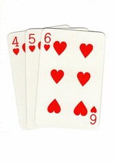 A hand of playing cards showing a run of three on a white background.