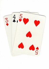 A hand of playing cards showing a run of three on a white background.