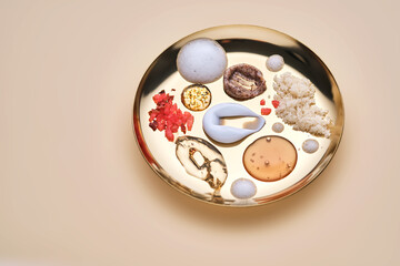 Various cosmetic textures on a golden tray.