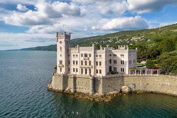 Naklejka premium Aerial view of the Miramare Castle at the Adriatic sea coast in Italy