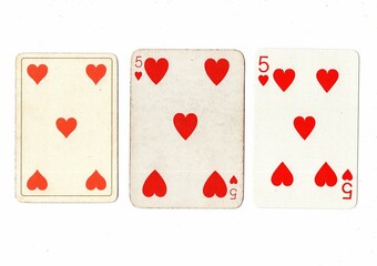 Vintage playing cards in three different designs showing the same value.