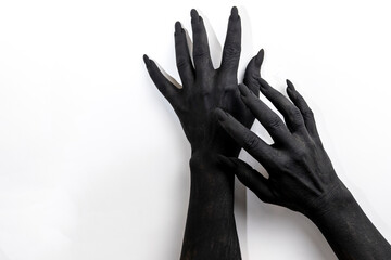 The woman hands with long nails painted in black color.