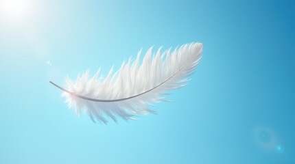 Obraz premium White feather floating mid-air against a bright blue sky, softly illuminated by sunlight, symbolizing freedom and lightness.
