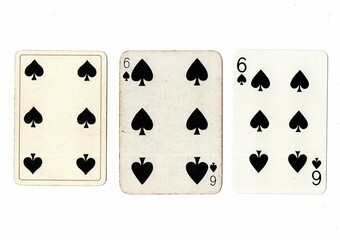 Three vintage playing cards of the same vale in different designs on a white background.