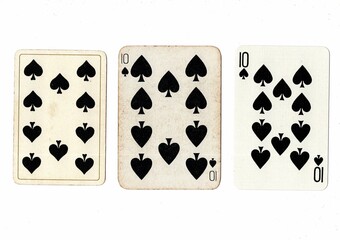 Vintage playing cards in three different designs showing the same value.
