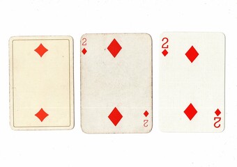 Vintage playing cards in three different designs showing the same value.