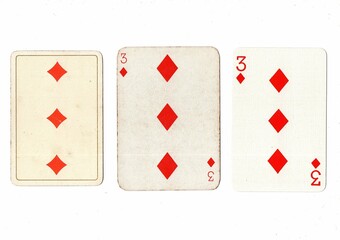 Vintage playing cards in three different designs showing the same value.