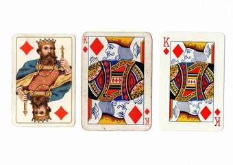 Vintage playing cards in three different designs showing the same value.