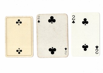 Vintage playing cards in three different designs showing the same value.