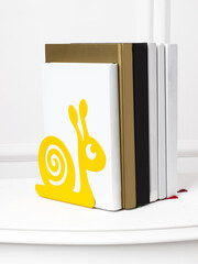Book stand in the form of a yellow snail