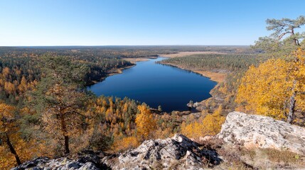 Obraz premium Autumn lake view from rocky peak, golden forest
