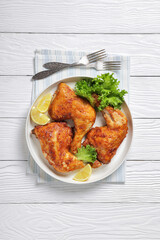 baked in oven three chicken leg quarters, top view