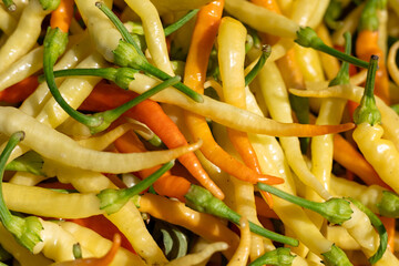 Colorful assortment of fresh chili peppers harvested in a local market during the summer season