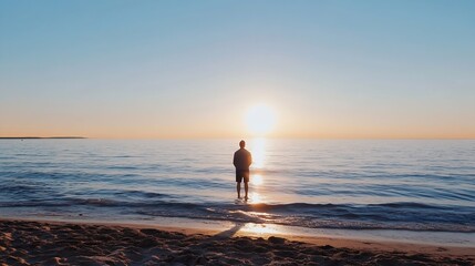 Fototapeta premium Silhouette of a Man Standing on a Beach at Sunset with Calm Ocean Waves : Generative AI