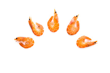 boiled shrimp with a bright orange shell laid out on a white background