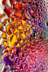 Close-up of water drops on metal surface in high resolution showing condensation of water droplets on metal surface. Intricate patterns and different sized water droplets create a beautiful abstract