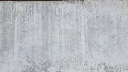 Old grey concrete wall texture with cracks and stains.
The building walls have white stains. 