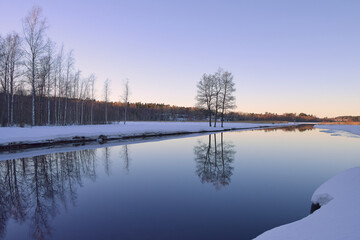 Tuusula Lake in March: evening, sunset time, reflection.