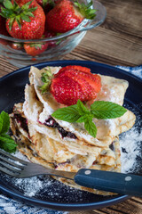 Polish pancakes with jam, cheese and strawberries.