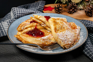Crepes with cheese and blackcurrant jam.