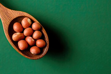 An organic spoonful of red annatto seeds from Bixa Orellana in a bowl