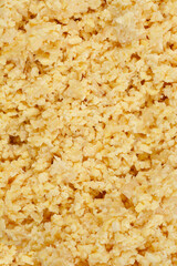 A close-up, top-down shot of blended raw soy, showing its coarse texture and pale yellow color