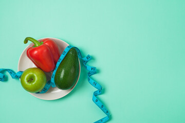 Healthy lifestyle and balanced eating concept with  apple, pepper and avocado on plate