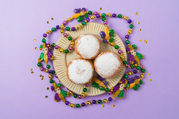 Mardi gras carnival polish donuts, beads and throws on purple background © maglara