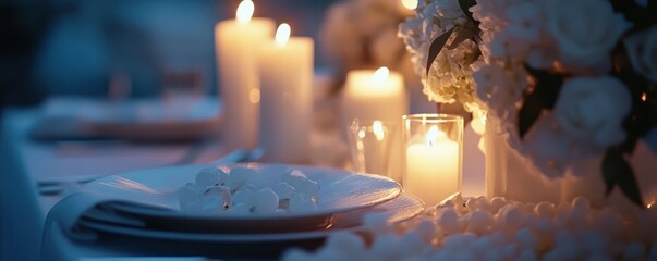 Elegant candlelit dinner setup with white flowers and plates in evening ambiance