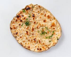 Garlic Naan traditional Indian flatbread with garlic and herbs , seen up close and from above isolated on a white background
