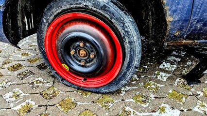 a flat spare tire on a car © Marcin