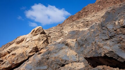 Fototapeta premium Stunning rocky cliff with vibrant textures under a clear blue sky showcasing natural beauty : Generative AI