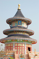 The ornate Wat Thawonwararam temple in Kanchanaburi, Thailand, showcases traditional Thai...