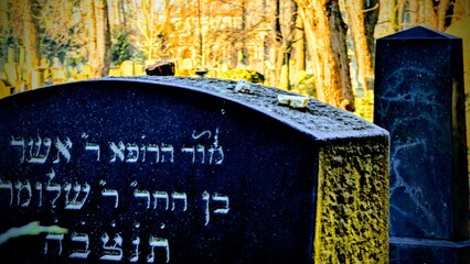 stones on the tombstone of the Jewish cemetery © Marcin
