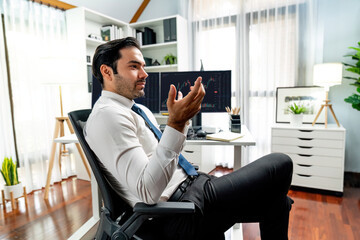 Smart trader businessman analyzing in two dynamic stock exchange investment screen on pc with investing highest profitable financial technology in searching market at modern home office. Surmise.