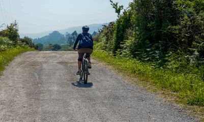 Naklejka premium A person cycling on a rural route