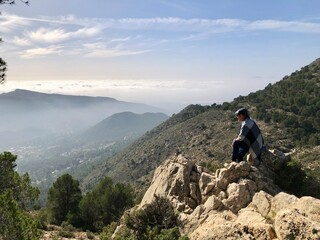 Adult man wearing square cap and blanket enjoying nature of Sierra Espuña, Murcia, Spain