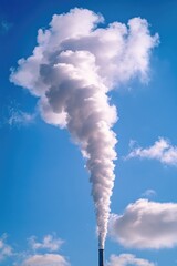 Industrial smoke stack against clear blue sky.