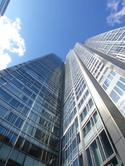 Obraz premium Tall modern skyscrapers reaching toward a bright blue sky creating a dramatic urban landscape : Generative AI