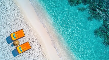 Tropical beach scene; lounge chairs, straw hat, sunny day; aerial view of turquoise water and white sand