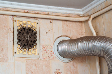 A dusty air vent and hose show neglected household cleaning and highlight poor ventilation.
