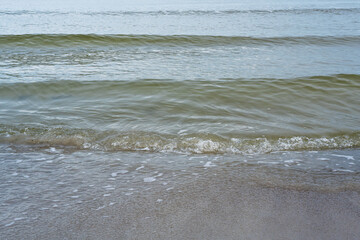 Sandy shore of the Baltic Sea with waves