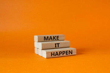 Make it Happen symbol. Concept words Make it Happen on wooden blocks. Beautiful orange background....