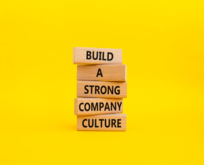 Company culture symbol. Wooden blocks with words Build a strong company culture. Beautiful yellow...
