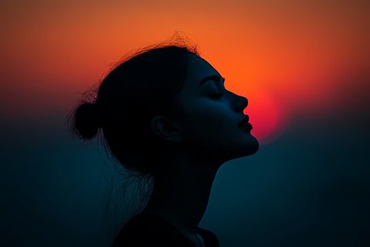 Silhouette of woman at sunset with vibrant sky