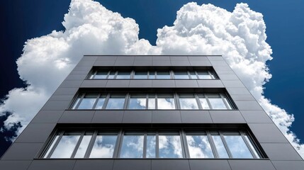 Obraz premium Modern office building against a dramatic sky. Low angle view. Possible use showcasing modern architecture